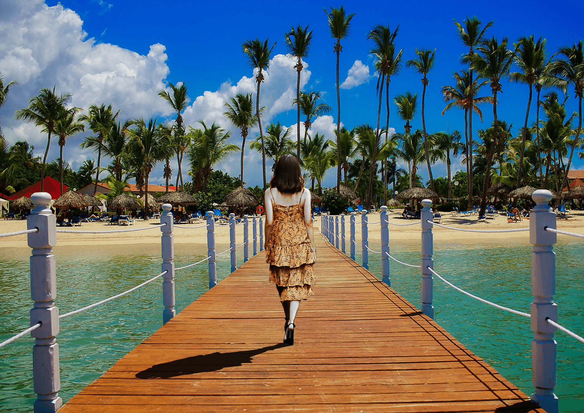 A photo of a woman walking down a deck on the ocean towards the shore